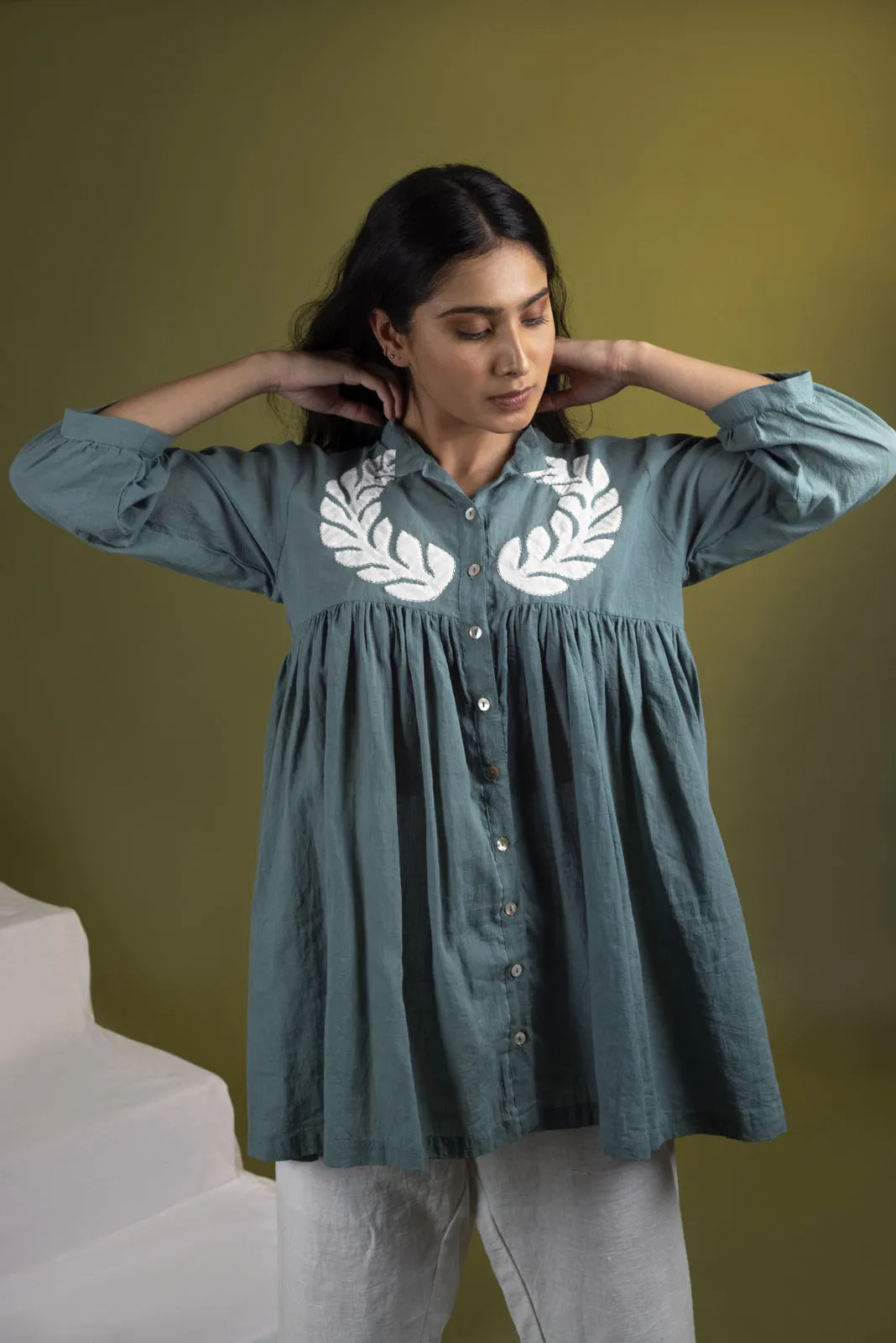 Teal applique gathered top with white pants