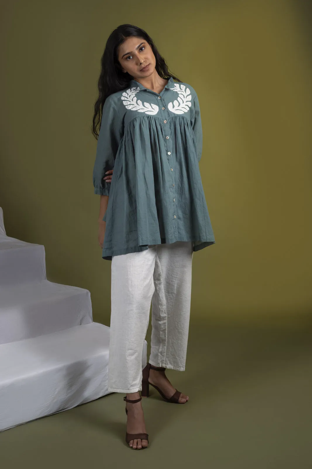 Teal applique gathered top with white pants