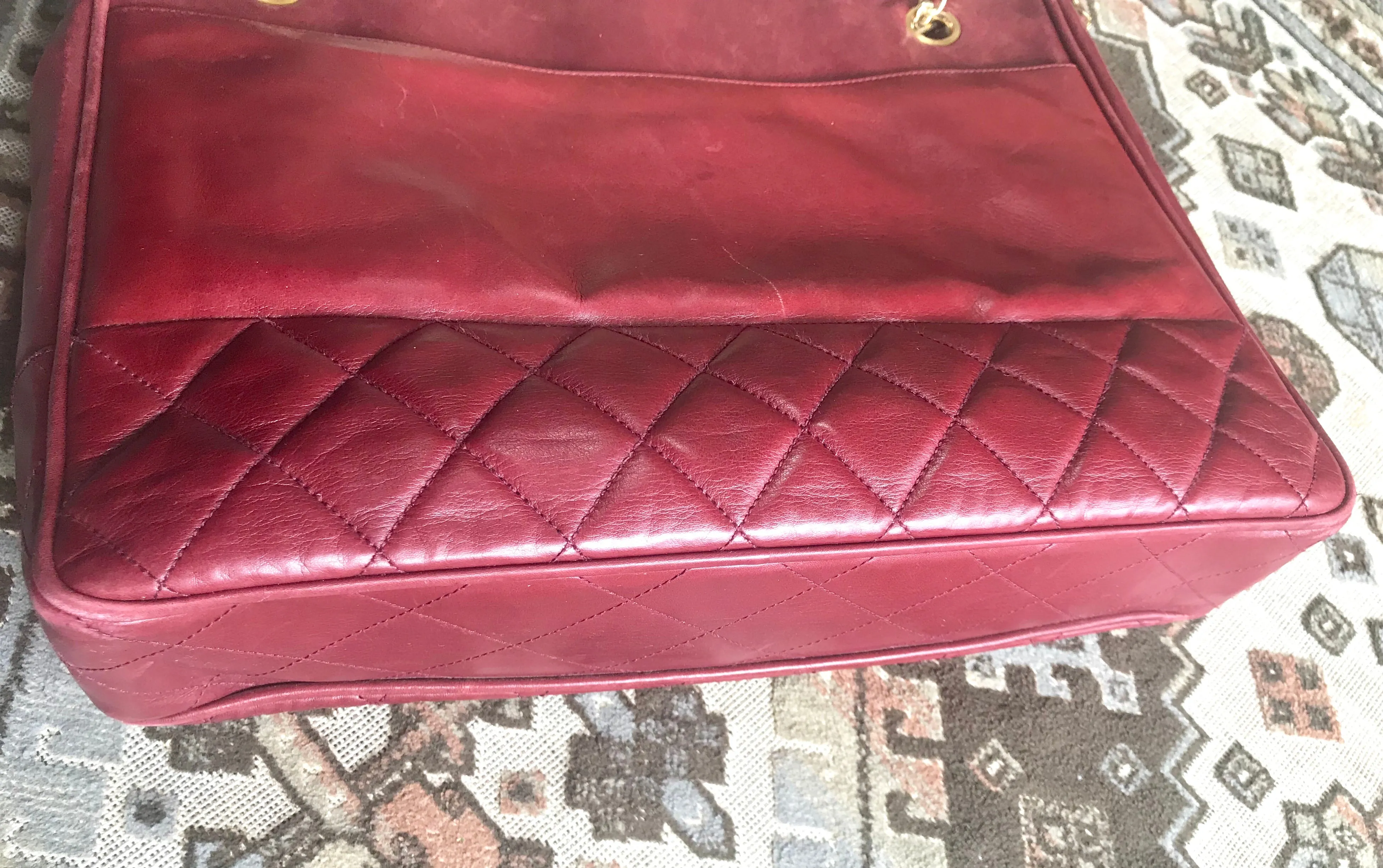 Vintage CHANEL wine leather tote bag with gold chain handles and CC motif charm. Classic purse.