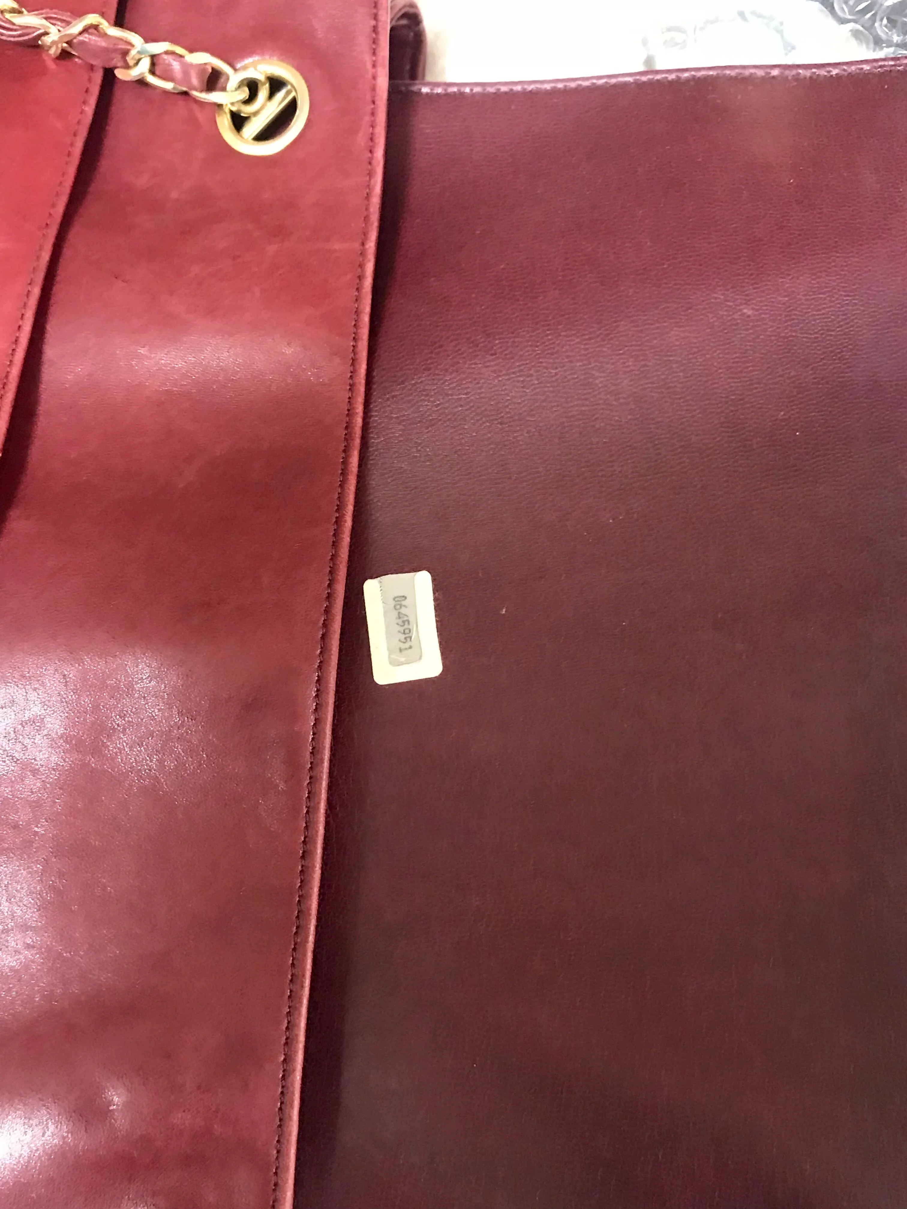 Vintage CHANEL wine leather tote bag with gold chain handles and CC motif charm. Classic purse.