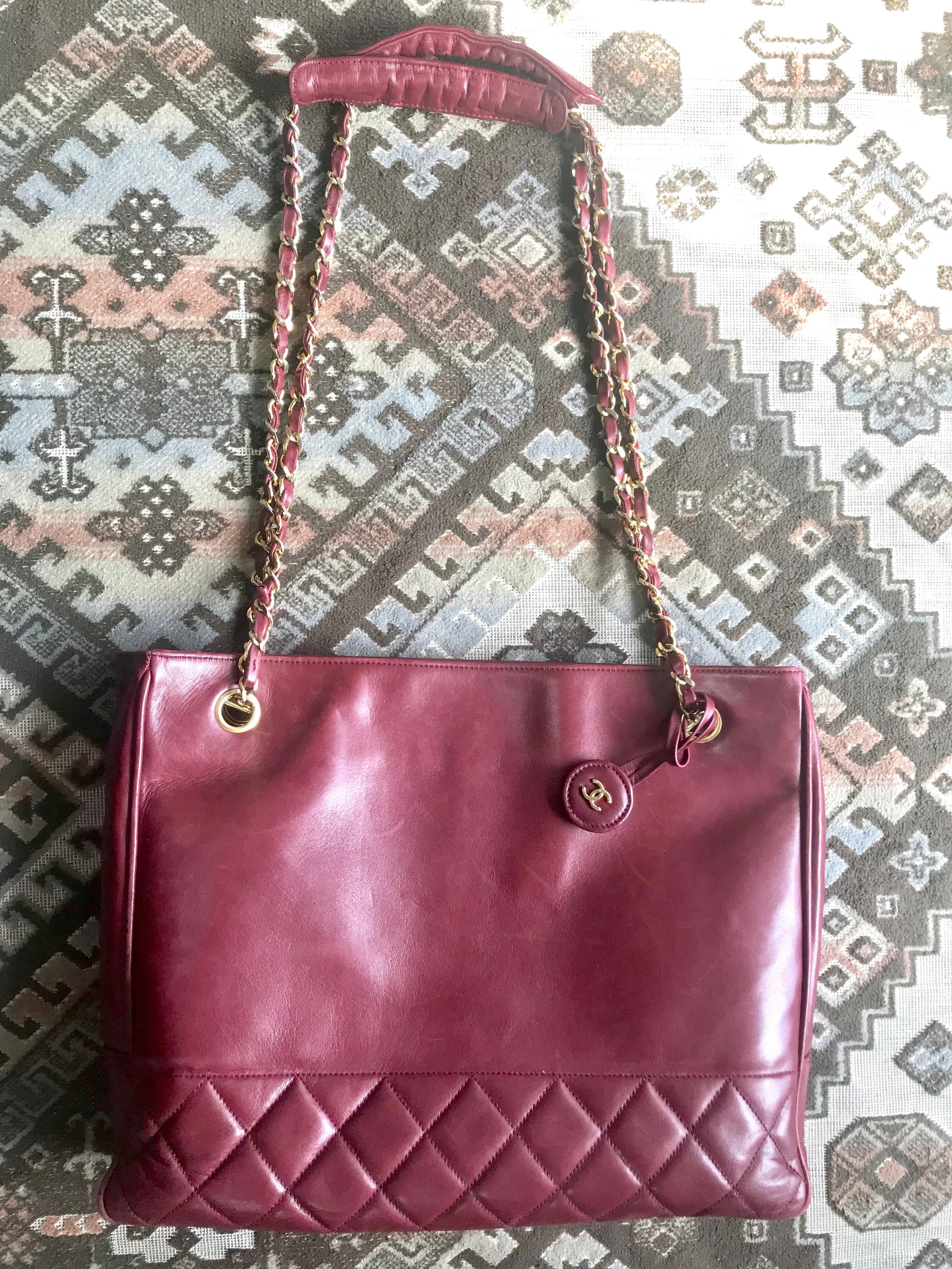 Vintage CHANEL wine leather tote bag with gold chain handles and CC motif charm. Classic purse.