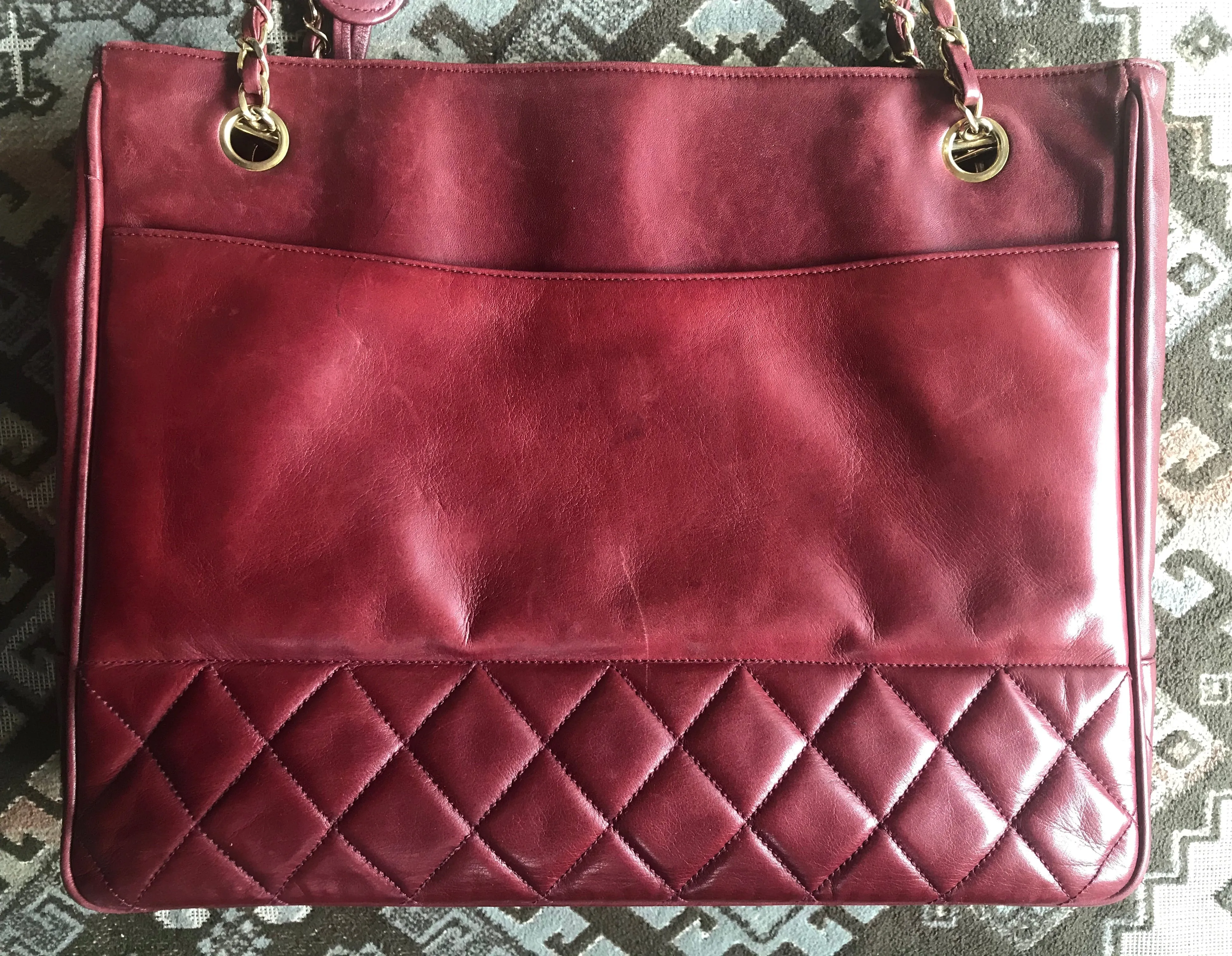 Vintage CHANEL wine leather tote bag with gold chain handles and CC motif charm. Classic purse.