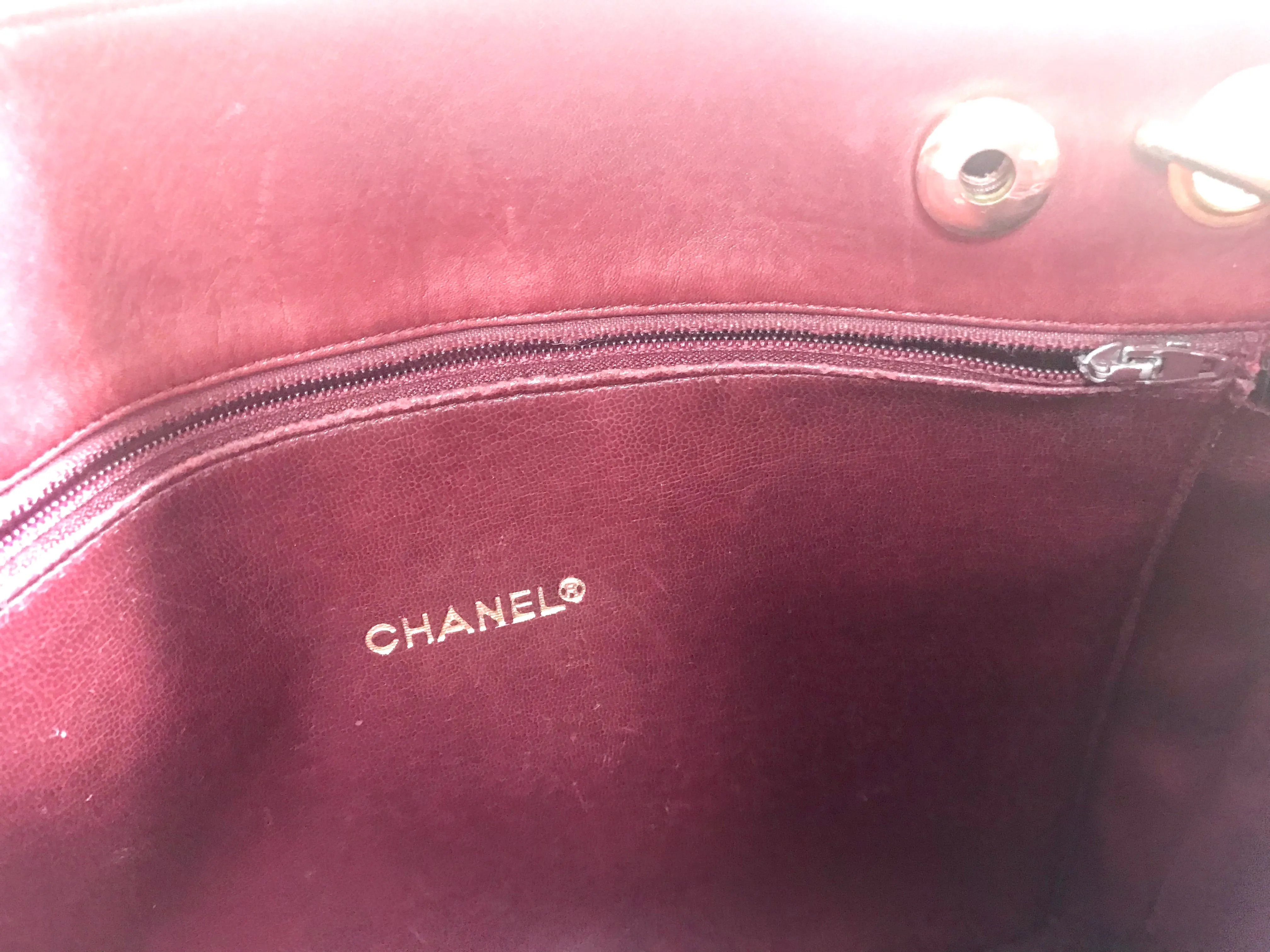 Vintage CHANEL wine leather tote bag with gold chain handles and CC motif charm. Classic purse.