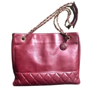 Vintage CHANEL wine leather tote bag with gold chain handles and CC motif charm. Classic purse.